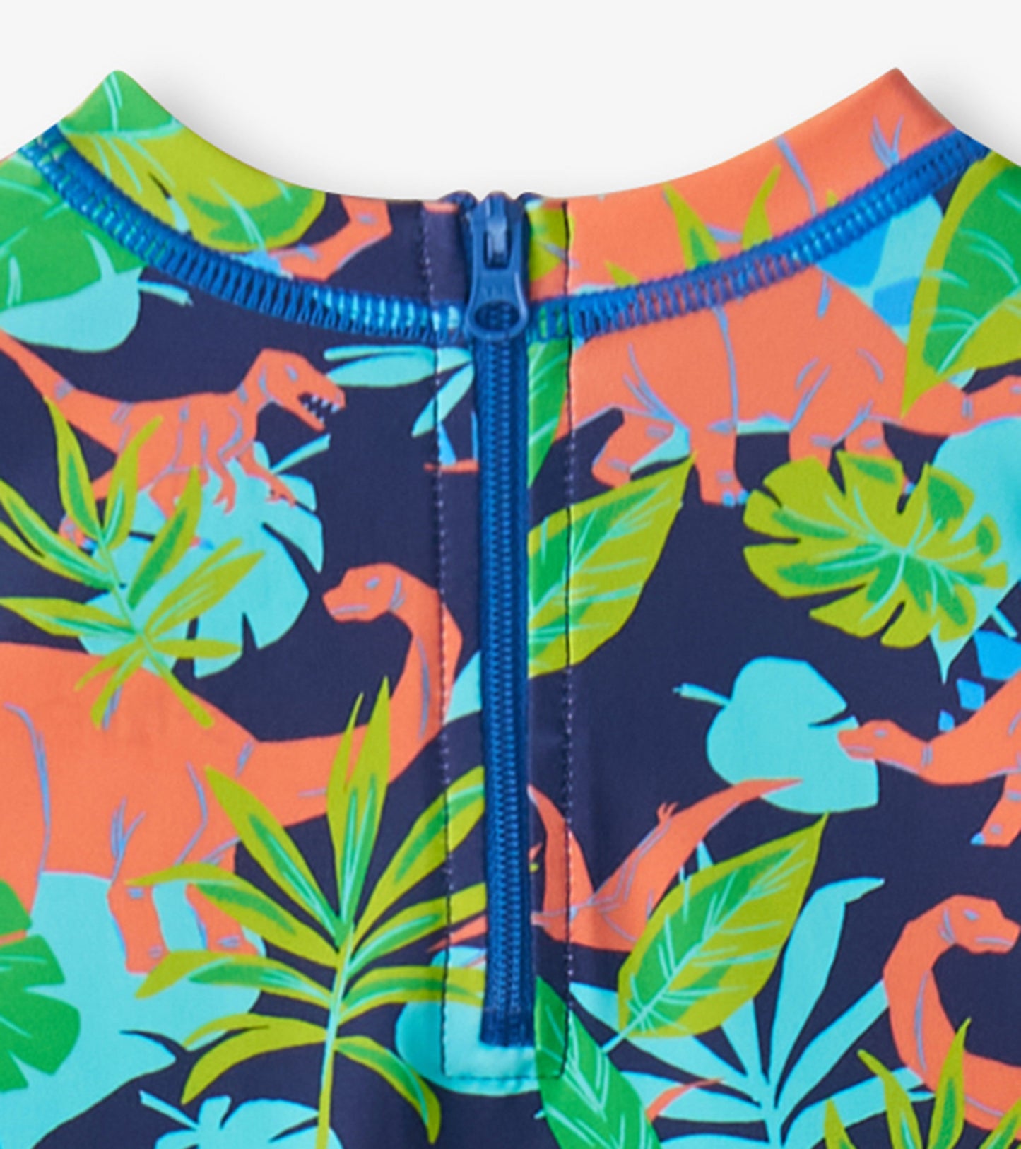 Navy one-piece rashguard featuring colorful dinosaur and tropical leaf patterns, with a blue zipper at the back.