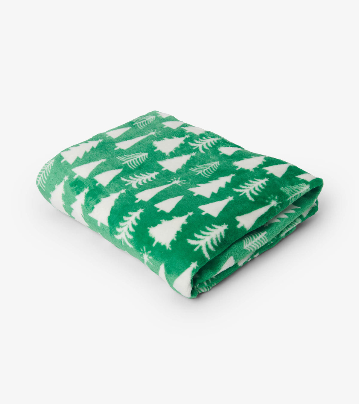 Folded green fuzzy fleece blanket with white Christmas tree print on a white background