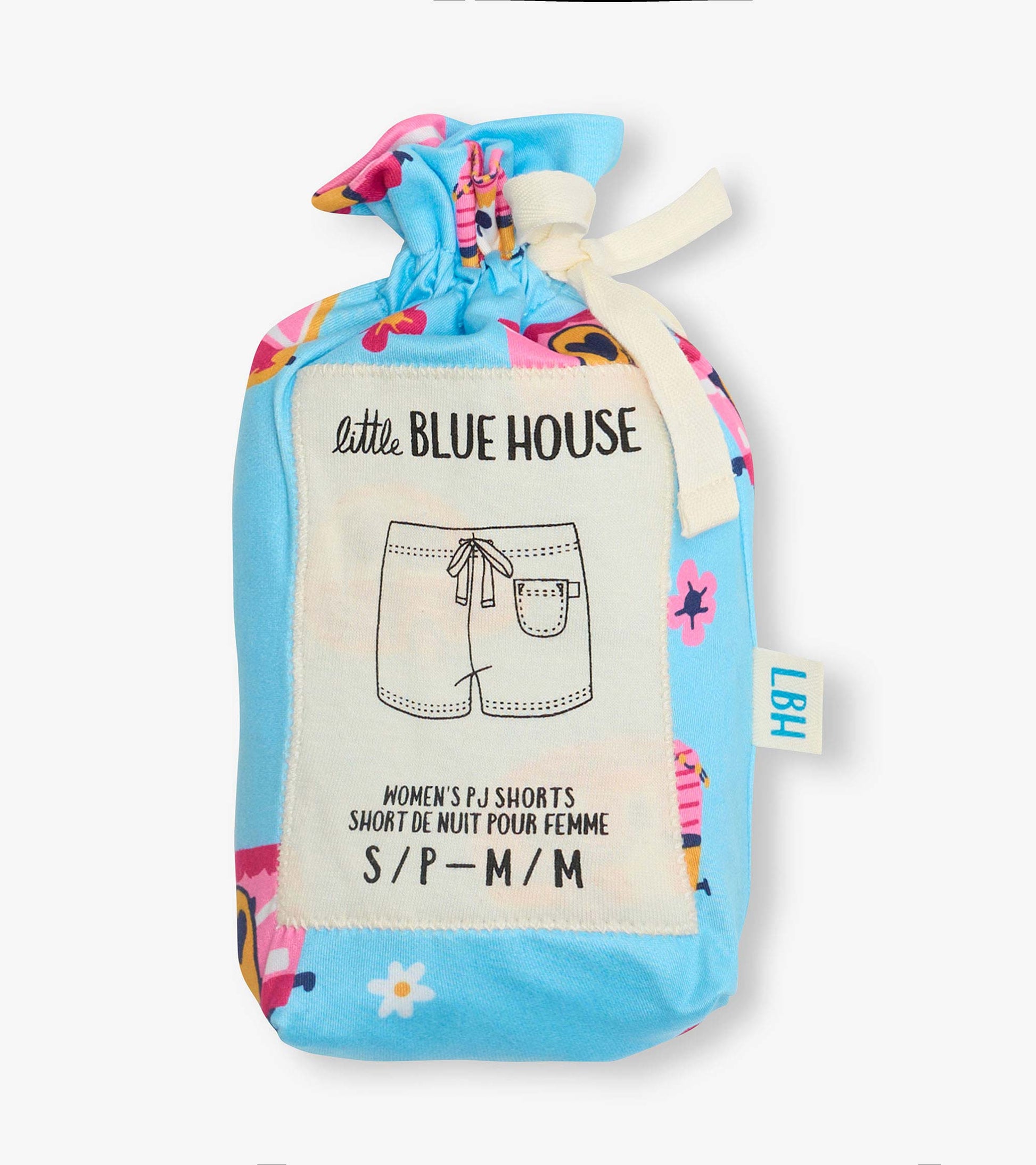 Folded blue pajama shorts with colorful retro camper and floral print, tied with cream ribbon, in a pouch
