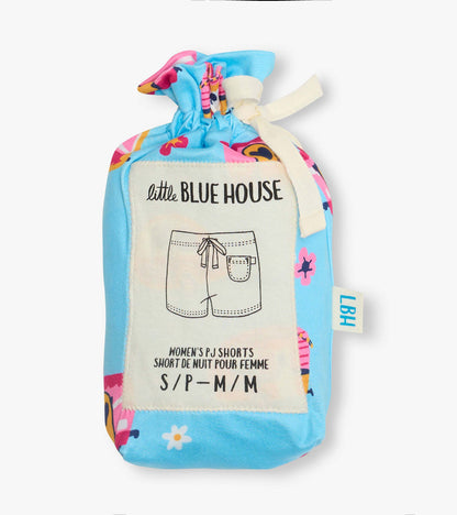 Folded blue pajama shorts with colorful retro camper and floral print, tied with cream ribbon, in a pouch