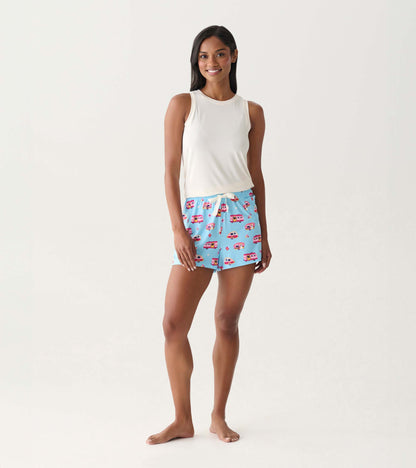 Blue pajama shorts with colorful camper print and white drawstring, shown on a model