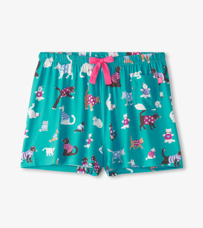 Front view of teal cat-print pajama shorts with an elastic waist, pink drawstring, and patch pocket
