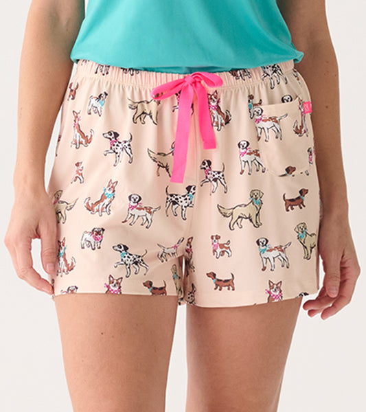 Close-up of blush pajama shorts with dog print, pink drawstring waist, and side patch pocket.