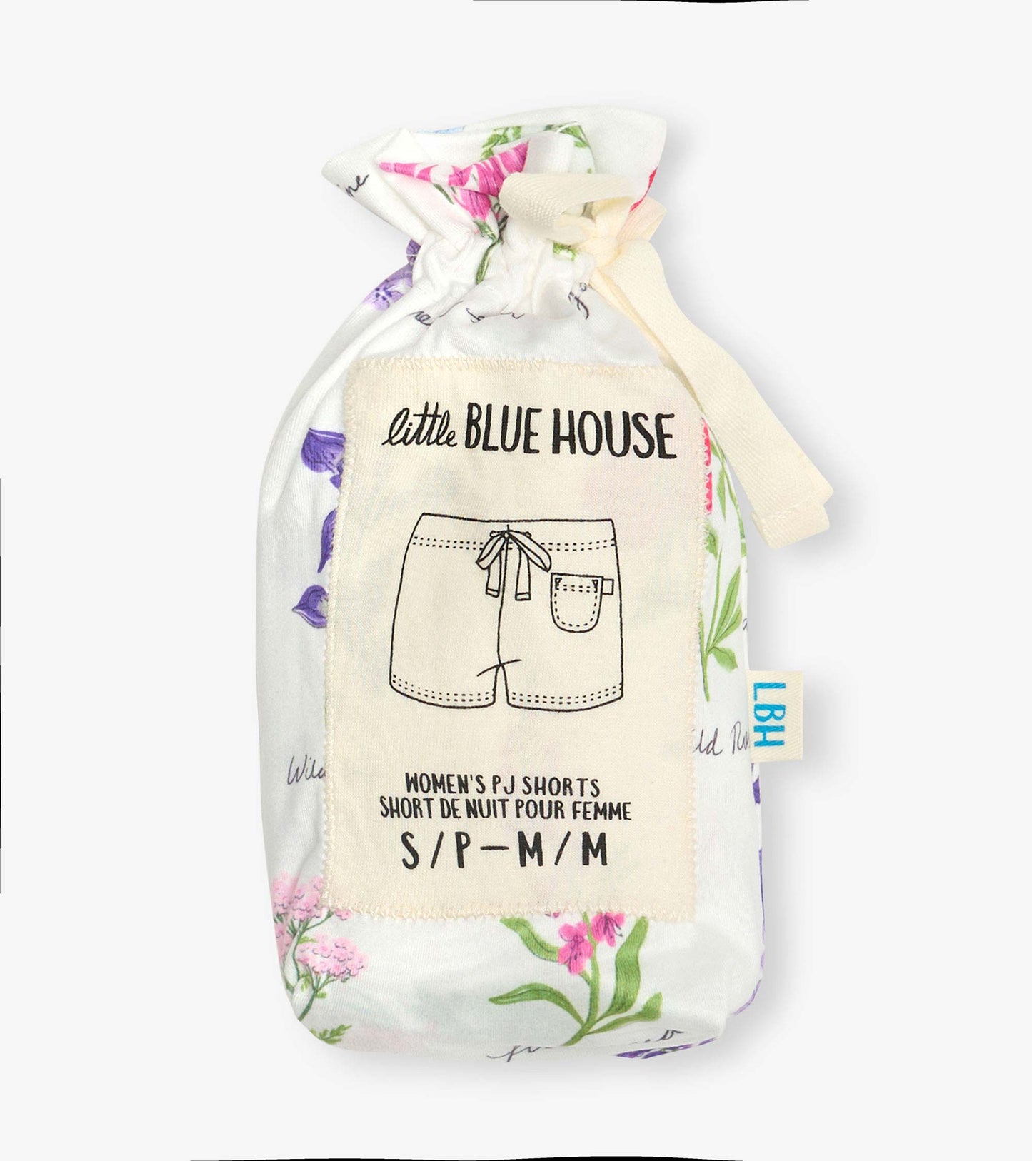 Folded white pajama shorts with pink and purple wildflower print, tied in a fabric pouch with label.