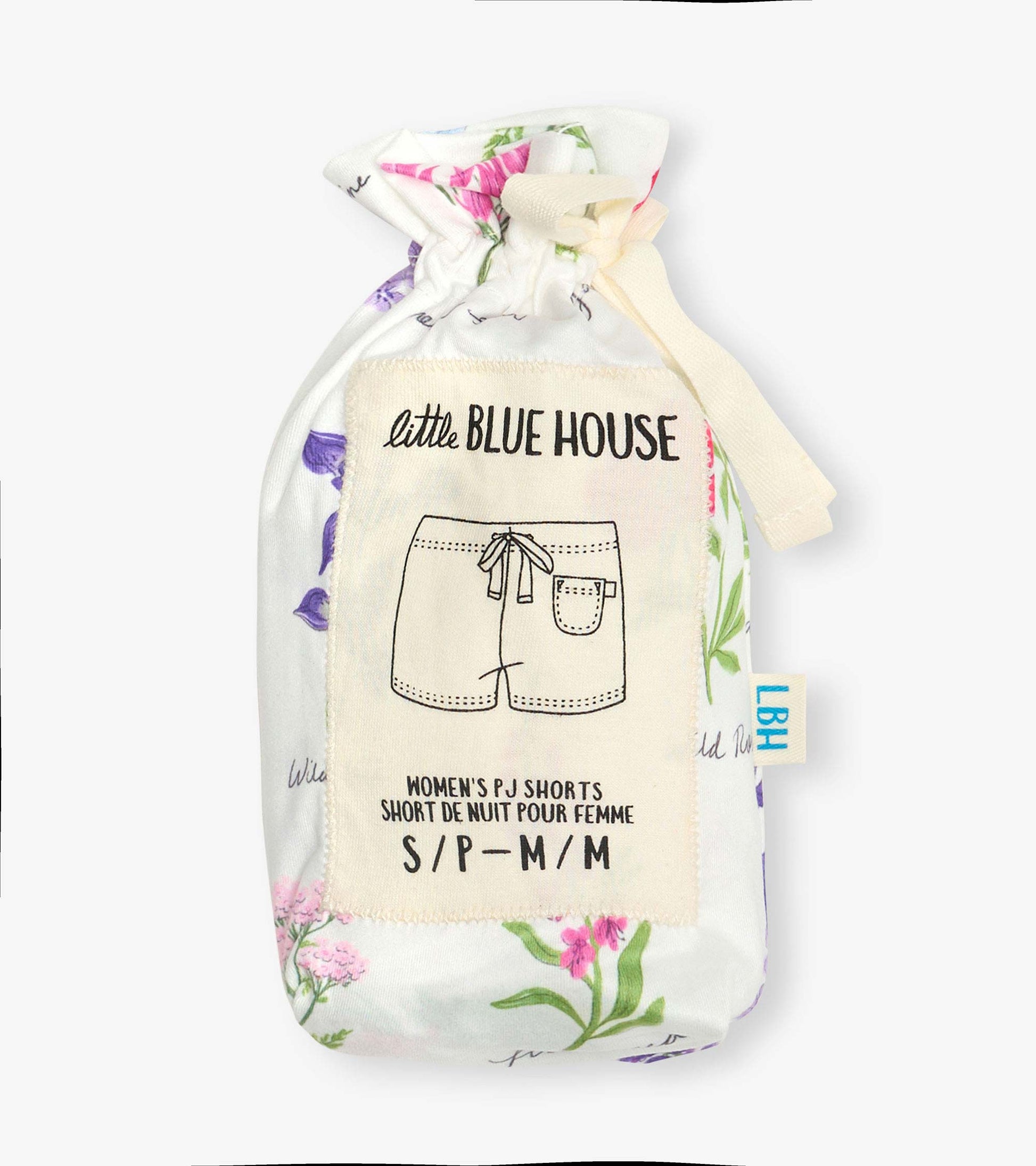 Folded white pajama shorts with pink and purple wildflower print, tied in a fabric pouch with label.