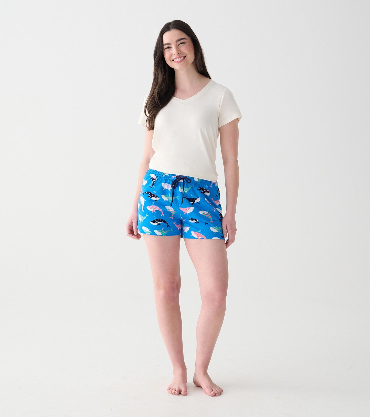 Model wearing blue whale-print boxers with a dark drawstring, front view