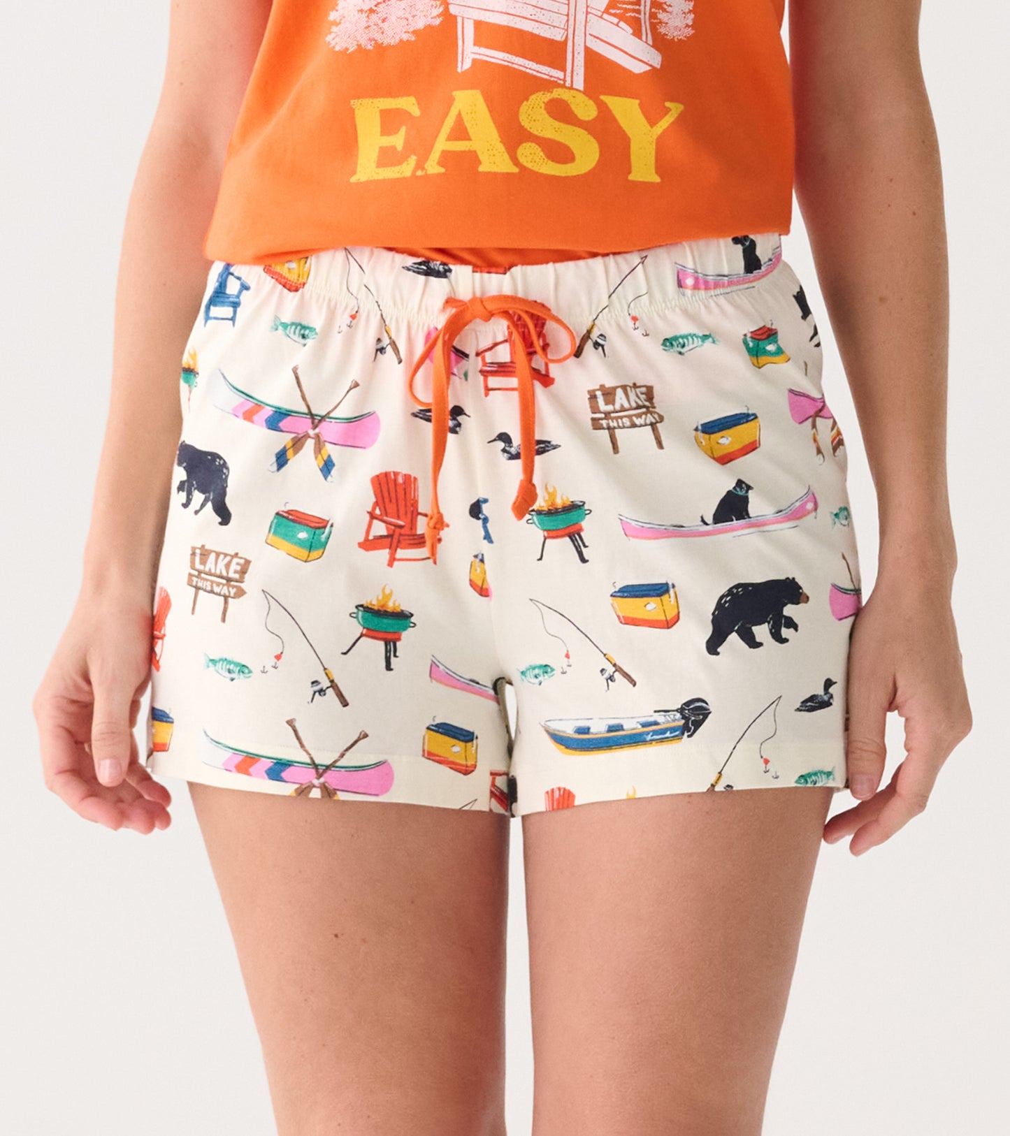 White cotton sleep shorts with colorful lake-themed print and orange drawstring, front view