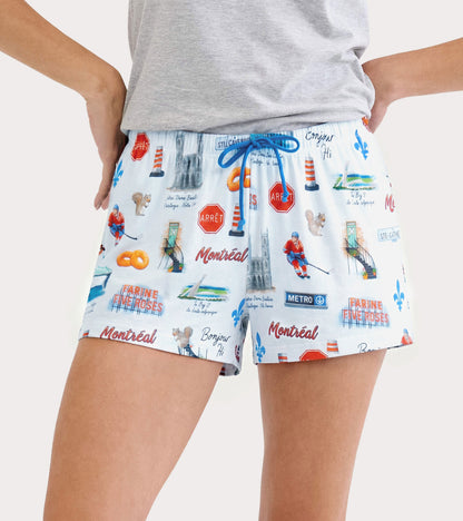 Model wearing white Montreal boxers with blue drawstring and city print featuring hockey players and landmarks