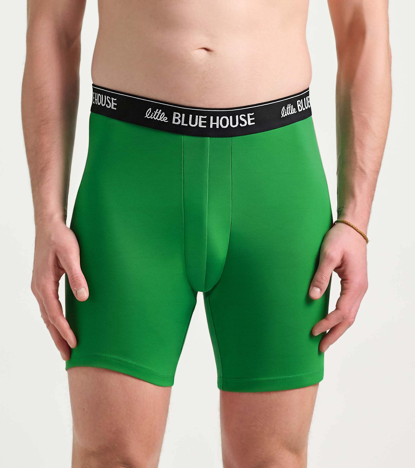 Green boxer briefs with a black logo waistband, shown on a male model front view