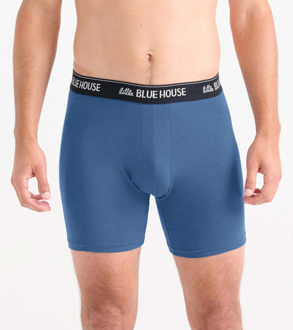 Front view of blue boxer briefs with a black logo waistband.