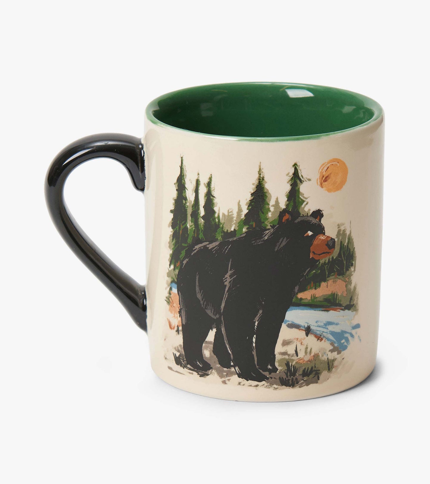Ceramic mug with black handle, green interior, and bear and forest print on cream background