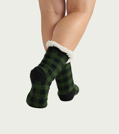 Forest green plaid women's socks with a cozy white Sherpa lining, perfect for cabin lounging.