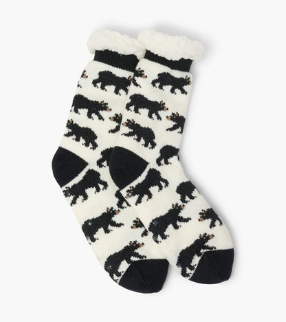 Cream socks with black bear patterns and a fluffy white cuff, designed for warmth and comfort. One size fits most.
