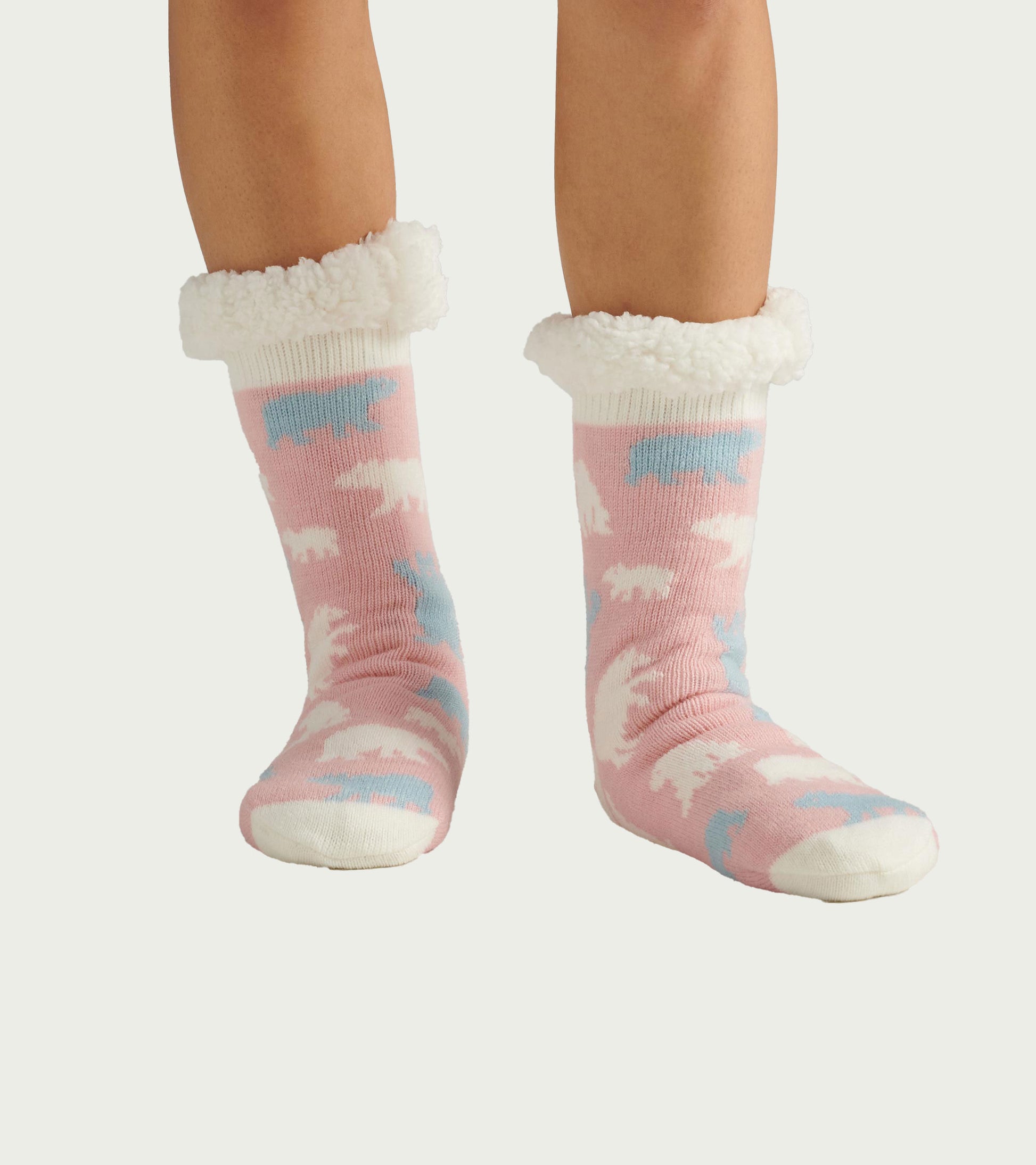 Pink sherpa-lined cabin socks with white, blue, and white polar bear pattern, shown on feet