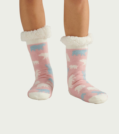 Pink sherpa-lined cabin socks with white, blue, and white polar bear pattern, shown on feet