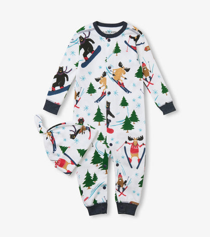 Front of baby sleeper and knot hat set with skiing animal and evergreen print on white
