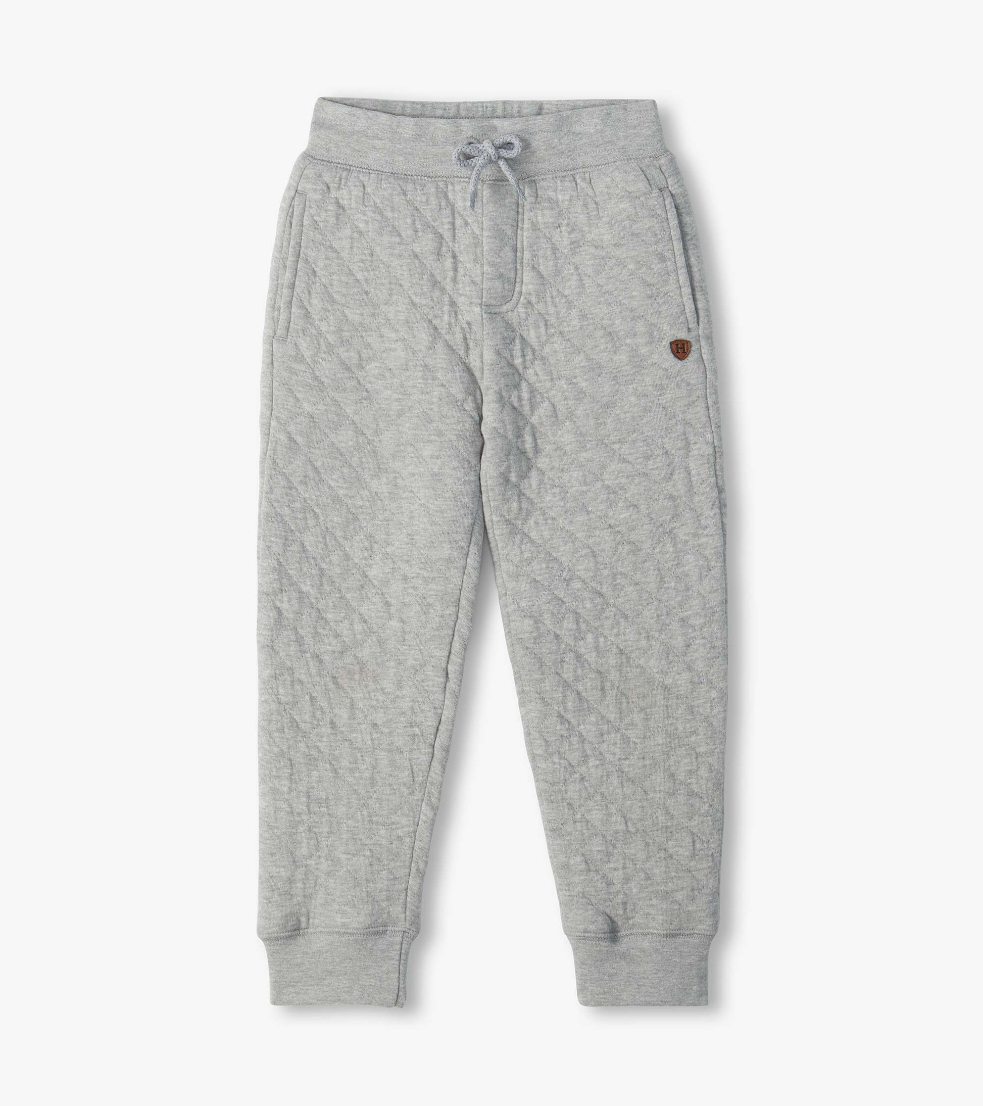 Athletic grey quilted jogger pants with drawstring waist, side pockets, and ribbed ankle cuffs