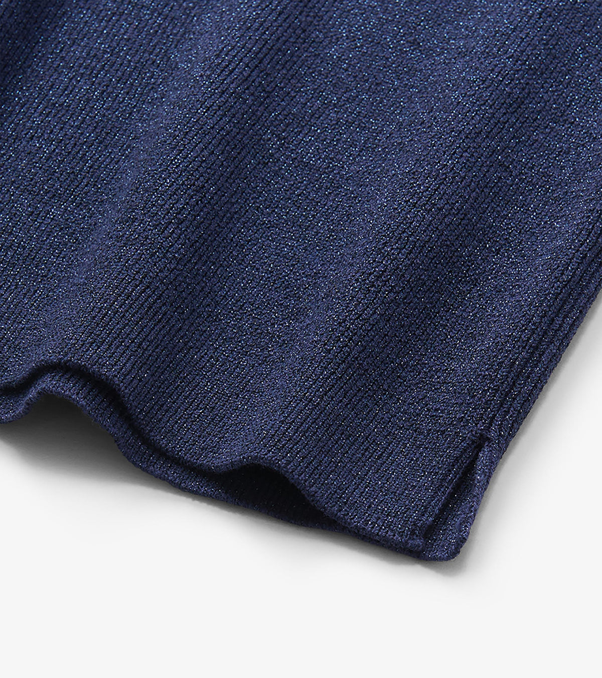 Close-up of patriot blue glitter knit with ribbed texture and scalloped hem detail