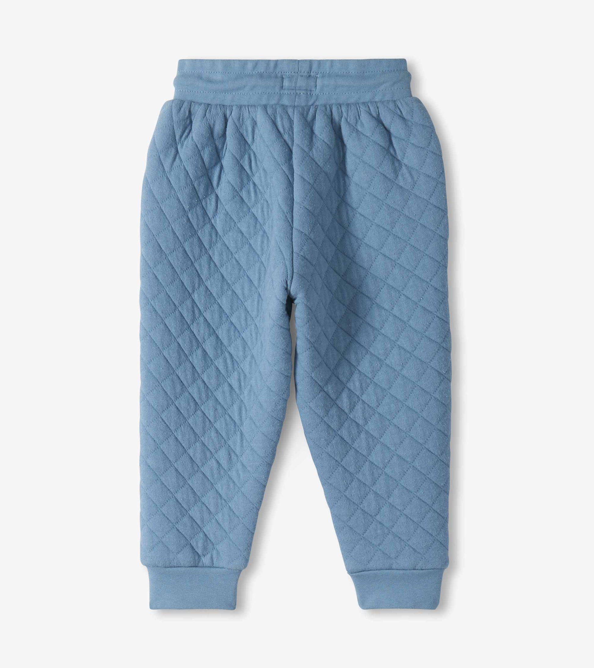 Back view of faded blue quilted joggers with an elastic waistband and ribbed cuffs
