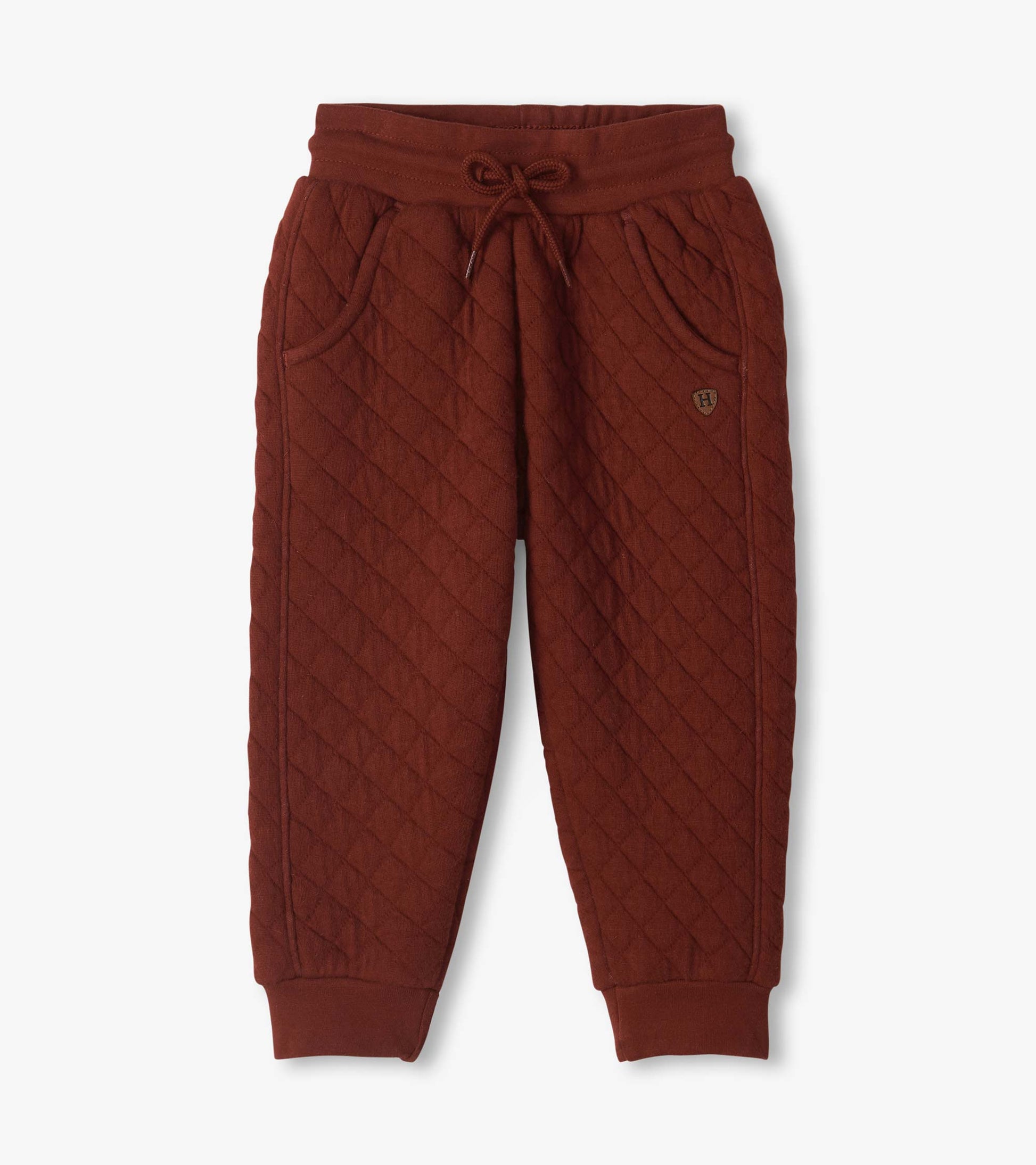 Madder brown quilted jogger pants with drawstring waist, side pockets, and ribbed ankle cuffs
