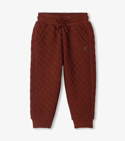 Madder brown quilted jogger pants with drawstring waist, side pockets, and ribbed ankle cuffs