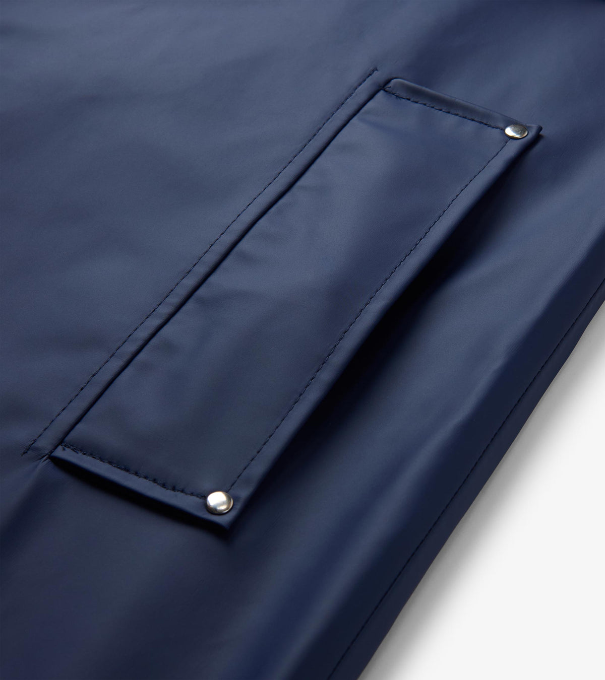 Close-up of patriot blue rain jacket front flap pocket with silver snap corners