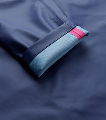 Close-up of patriot blue rain jacket cuff with light blue ribbed lining and a pink stripe.