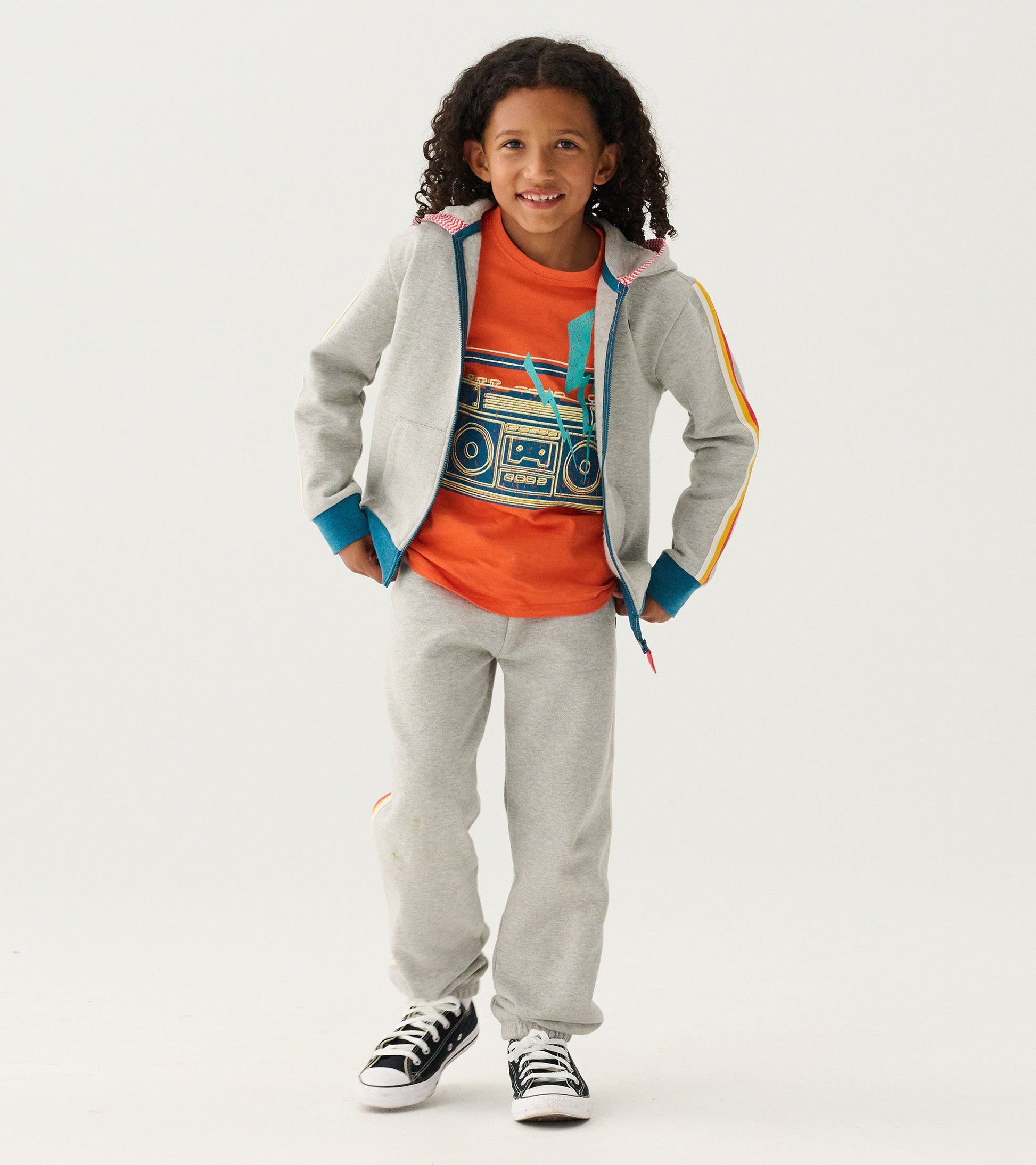 Grey baggy track pants made of soft material, designed for boys, featuring a relaxed fit for athletic wear.
