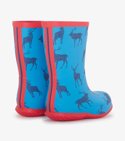 Blue rain boots featuring a deer pattern and red accents, designed for kids, with a flexible, packable material.