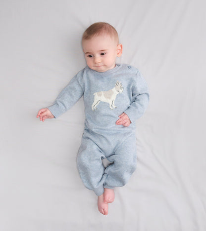 Light blue knit baby romper with a bulldog graphic, long sleeves, and footed legs, shown on a baby lying down