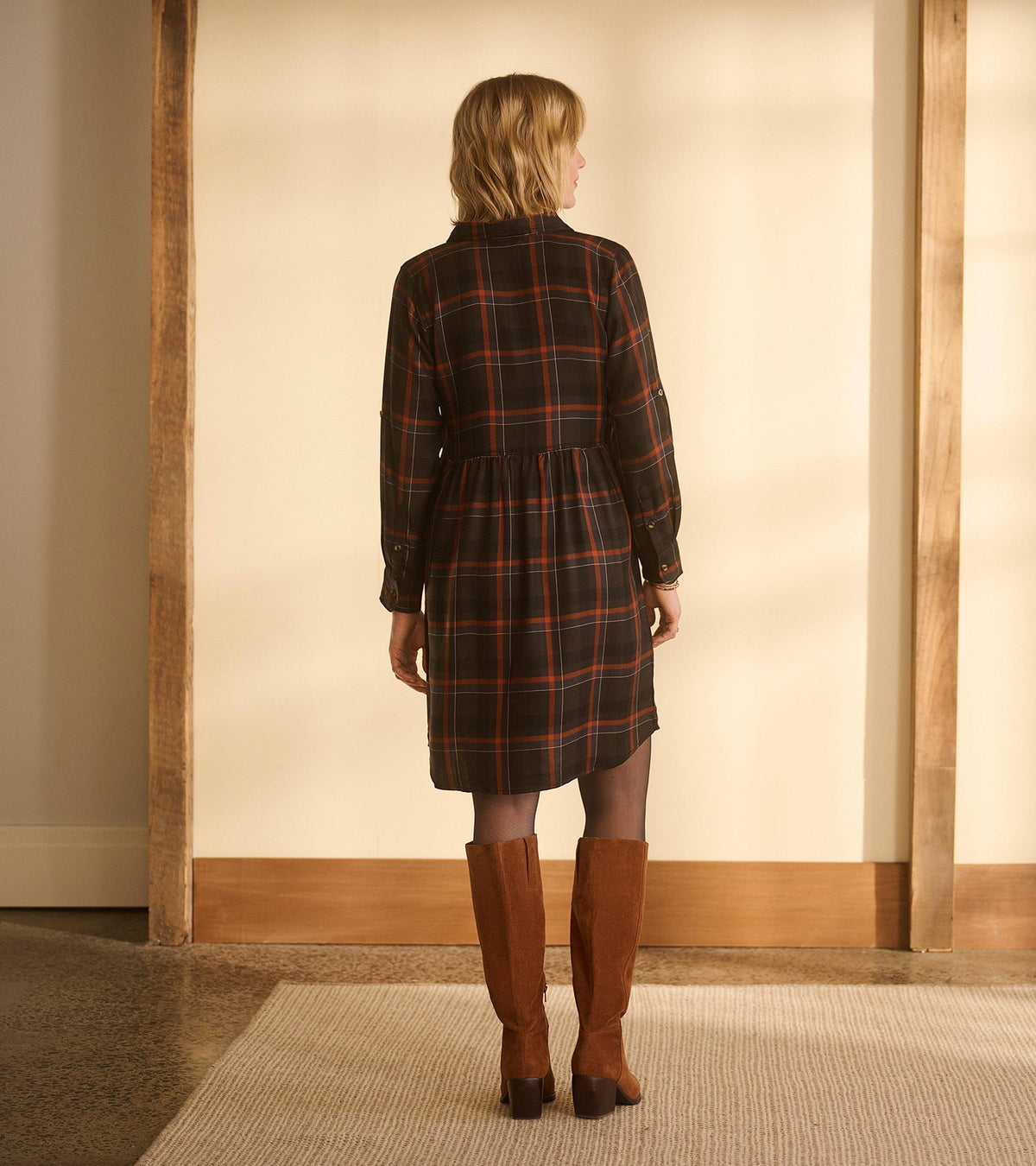 Back view of women's autumn plaid shirt dress with long sleeves and a gathered waist seam