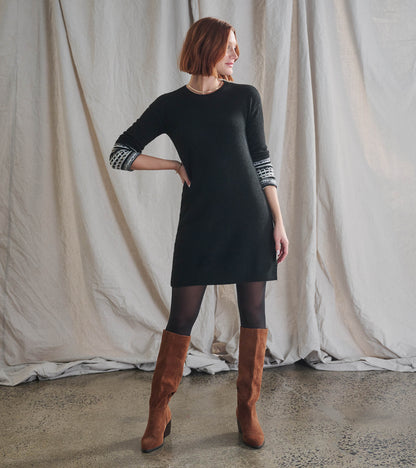 Black knit sweater dress with patterned three-quarter sleeves, shown on a model