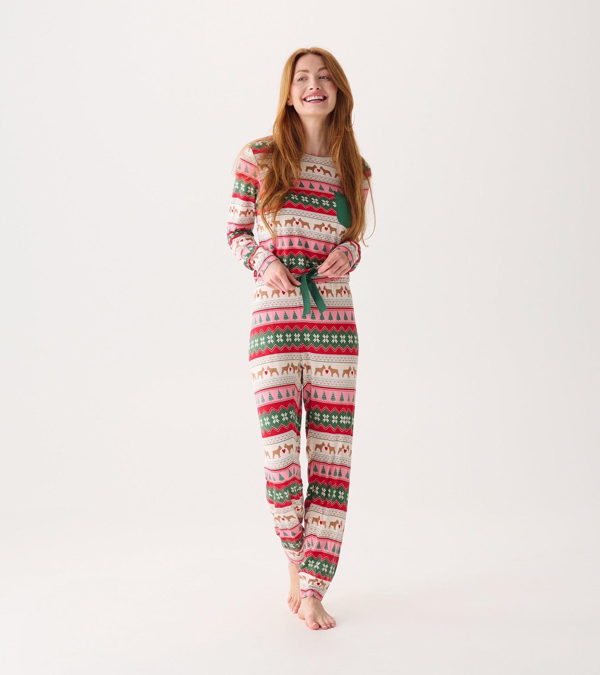 Long-sleeve pajama set featuring a festive Fairisle pattern with hearts, trees, and animals in red, green, and pink.