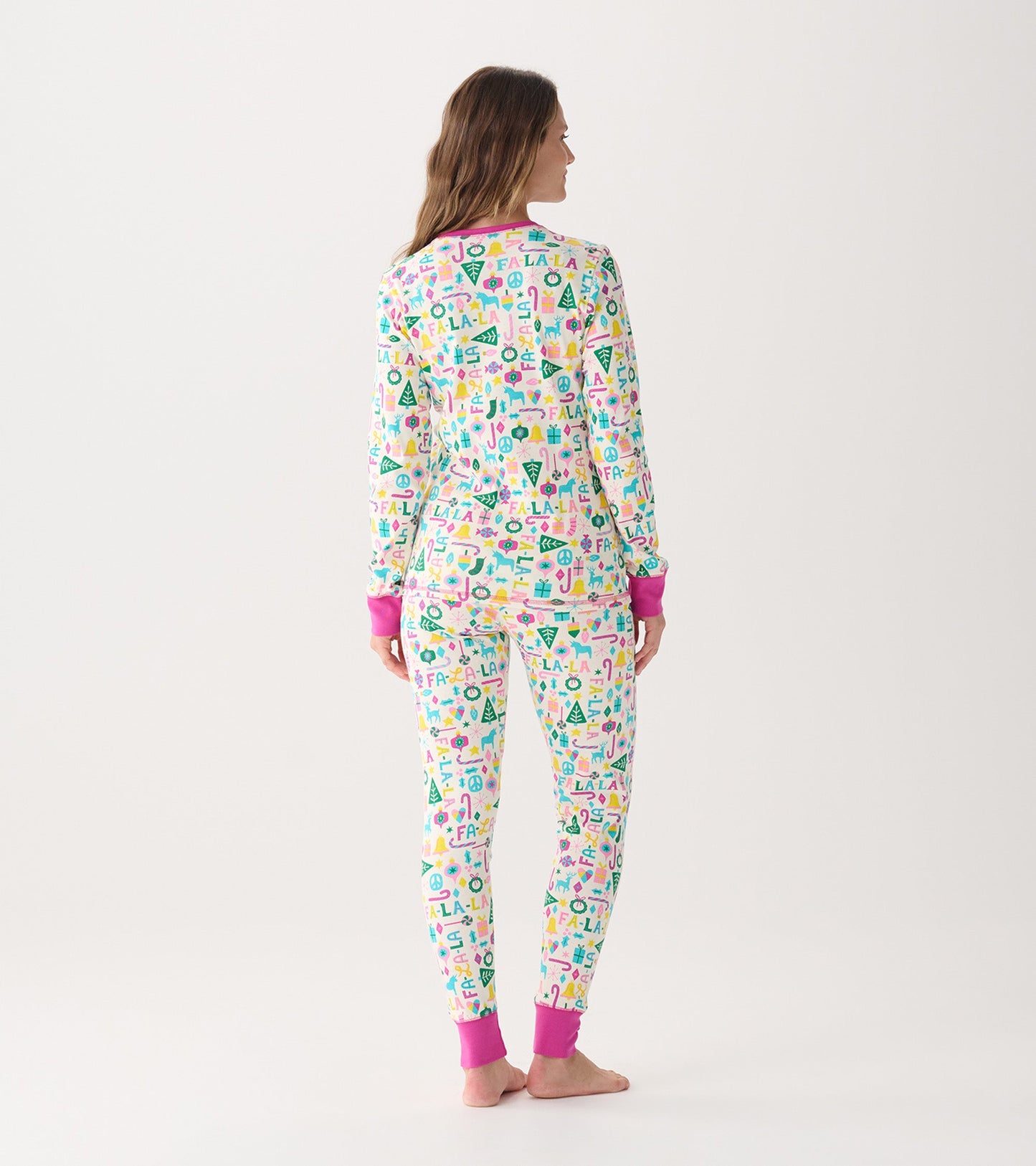 Women's pink pajama set featuring colorful holiday-themed patterns and contrasting pink cuffs, shown from the back.