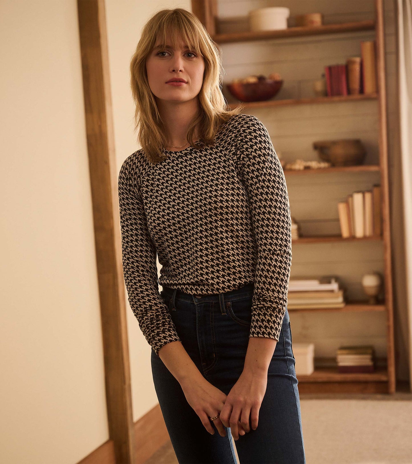 Front view of Chantel pullover in black and cream houndstooth, styled with dark jeans