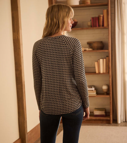 Back view of Chantel pullover in black and cream houndstooth with long sleeves and a curved hem