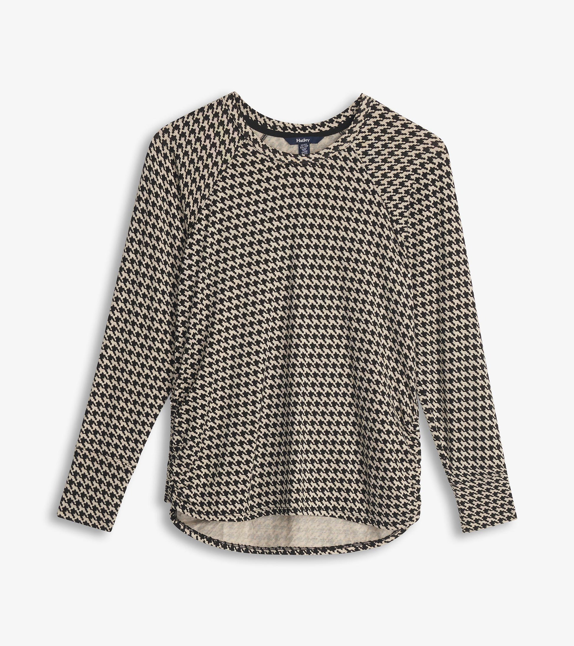 Chantel pullover in black and cream houndstooth with long sleeves and a curved hem, shown flat