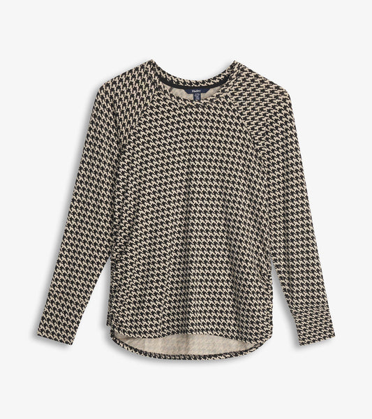 Chantel pullover in black and cream houndstooth with long sleeves and a curved hem, shown flat