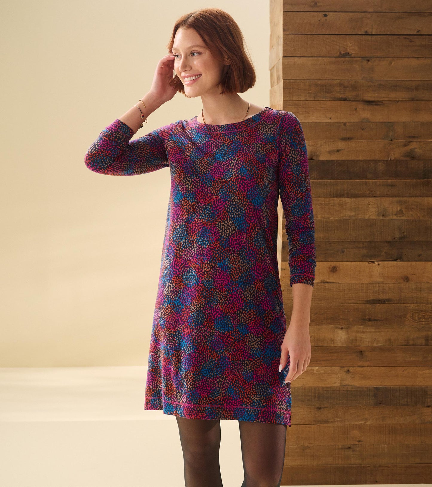 Long-sleeve multicolor dot-print shift dress with round neckline and above-knee hem, front view