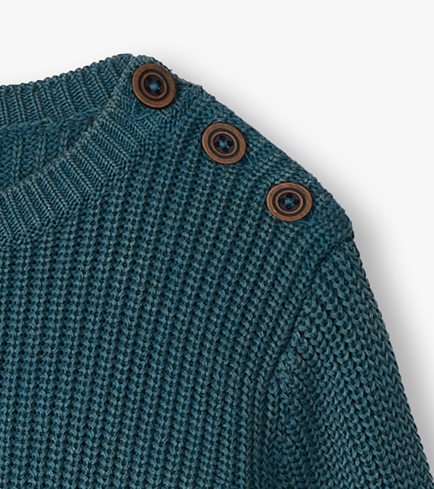 Close-up of blue knit sweater shoulder with three brown buttons at the button neck
