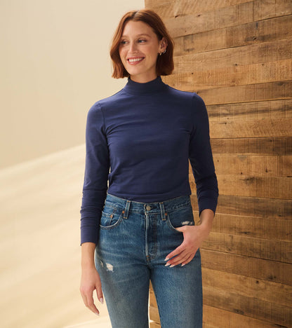 Model wearing patriot blue mock neck top with long sleeves, front view