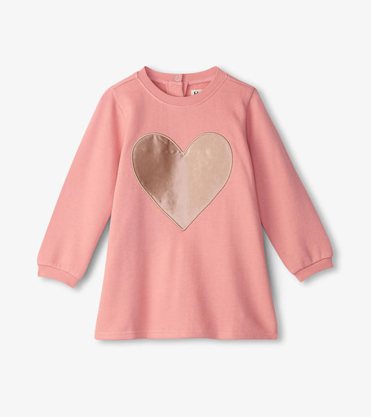 Pink long-sleeve dress featuring a large beige heart appliqué on the front, made from soft, cozy material.
