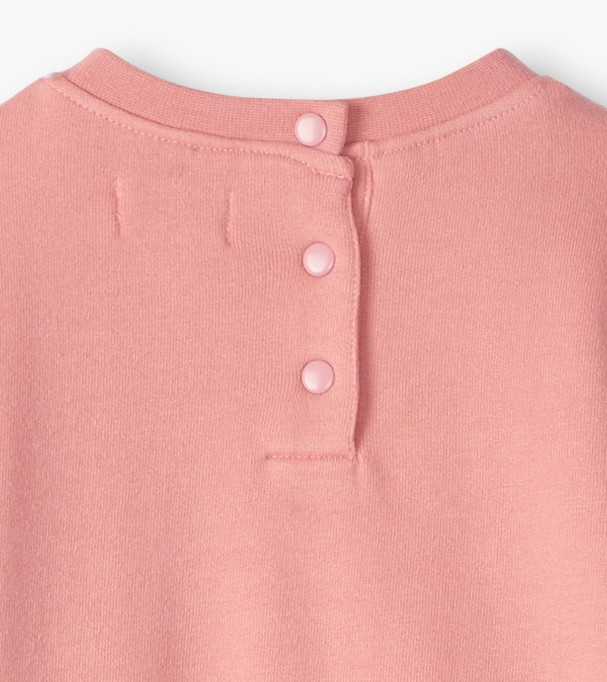 Light pink cozy dress with a round neckline and three button closure at the back. Soft fabric suitable for baby and toddler…