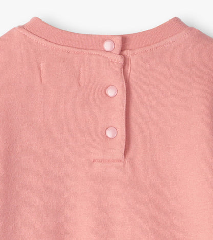 Light pink cozy dress with a round neckline and three button closure at the back. Soft fabric suitable for baby and toddler…