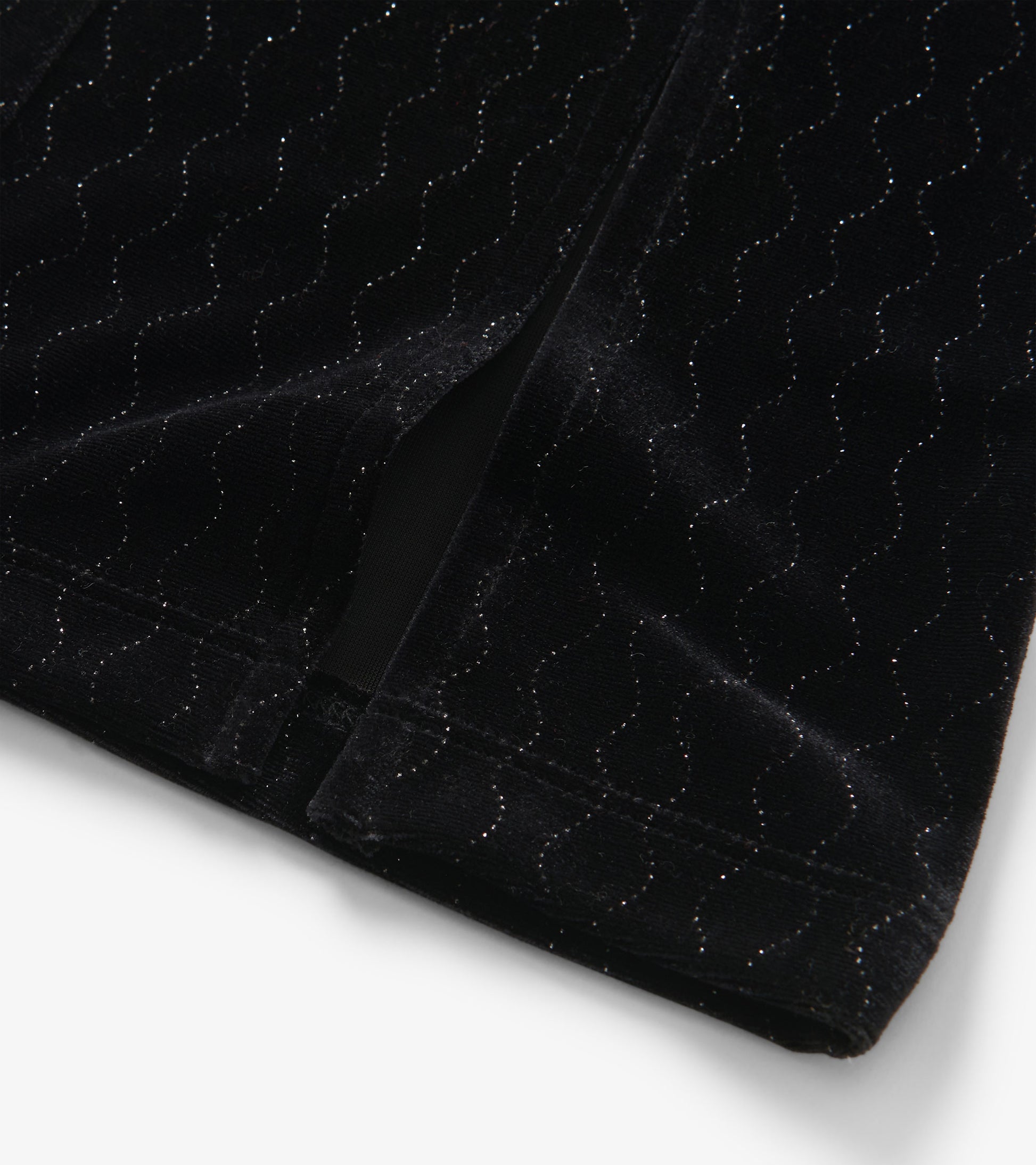 Black velour flared pants with a wavy sparkle pattern, showcasing a soft texture and stylish silhouette.