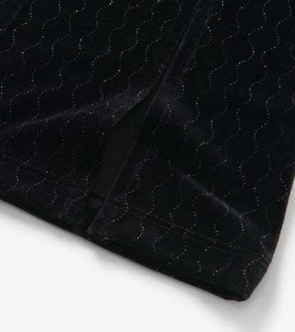 Black velour flared pants with a wavy sparkle pattern, showcasing a soft texture and stylish silhouette.