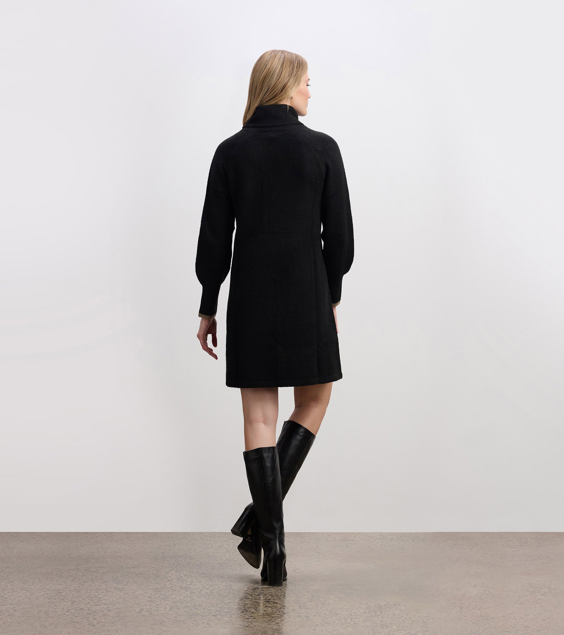 Black sweater dress with a high collar and long sleeves, featuring a relaxed fit and knee-length design.