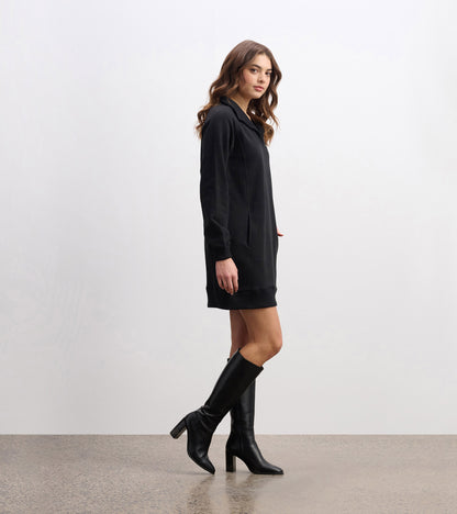 Black notch neck dress with long sleeves and pockets, styled with knee-high black boots.