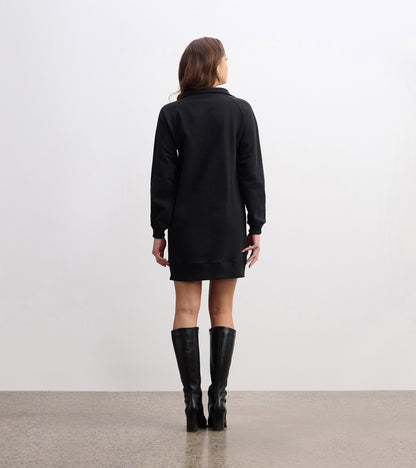 Black notch neck dress with long sleeves, featuring a relaxed fit and reaching mid-thigh, styled with knee-high boots.