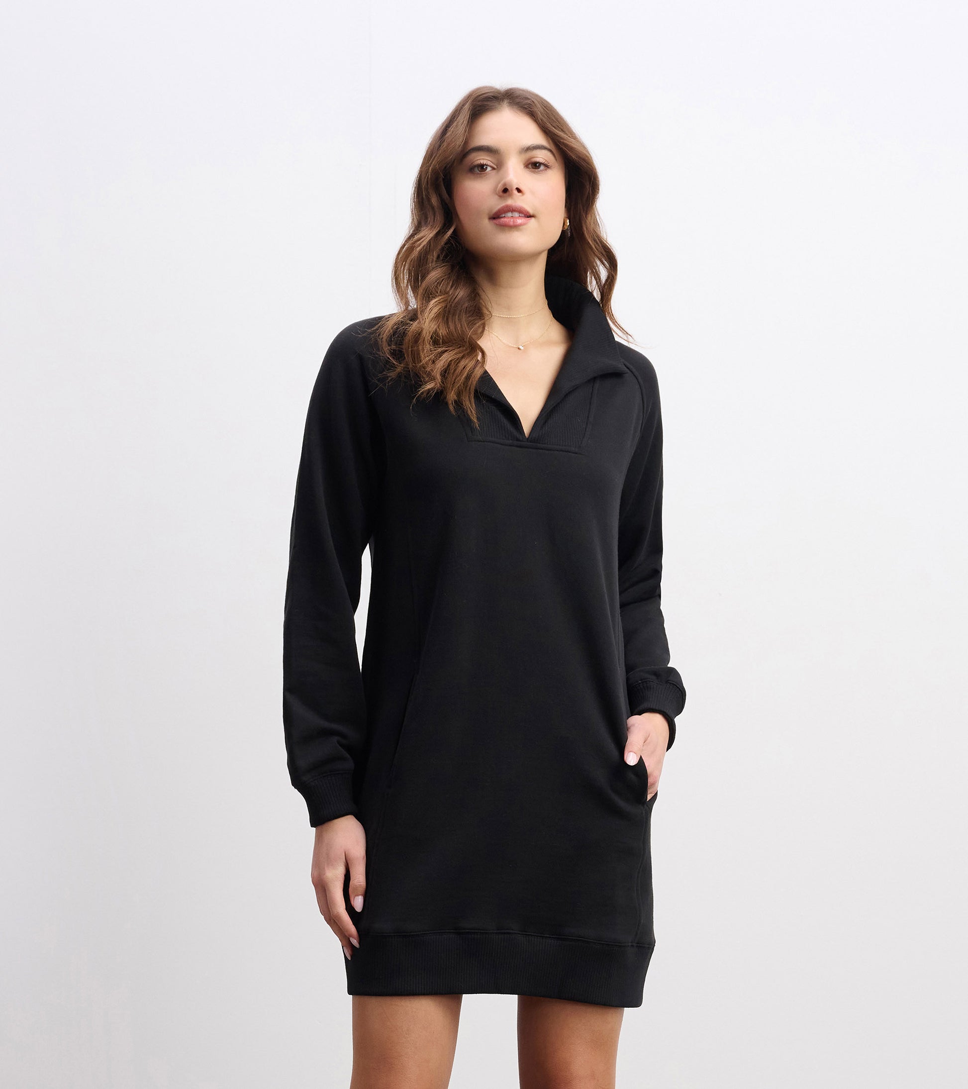 Black notch neck dress with long sleeves and side pockets, designed for a relaxed fit.